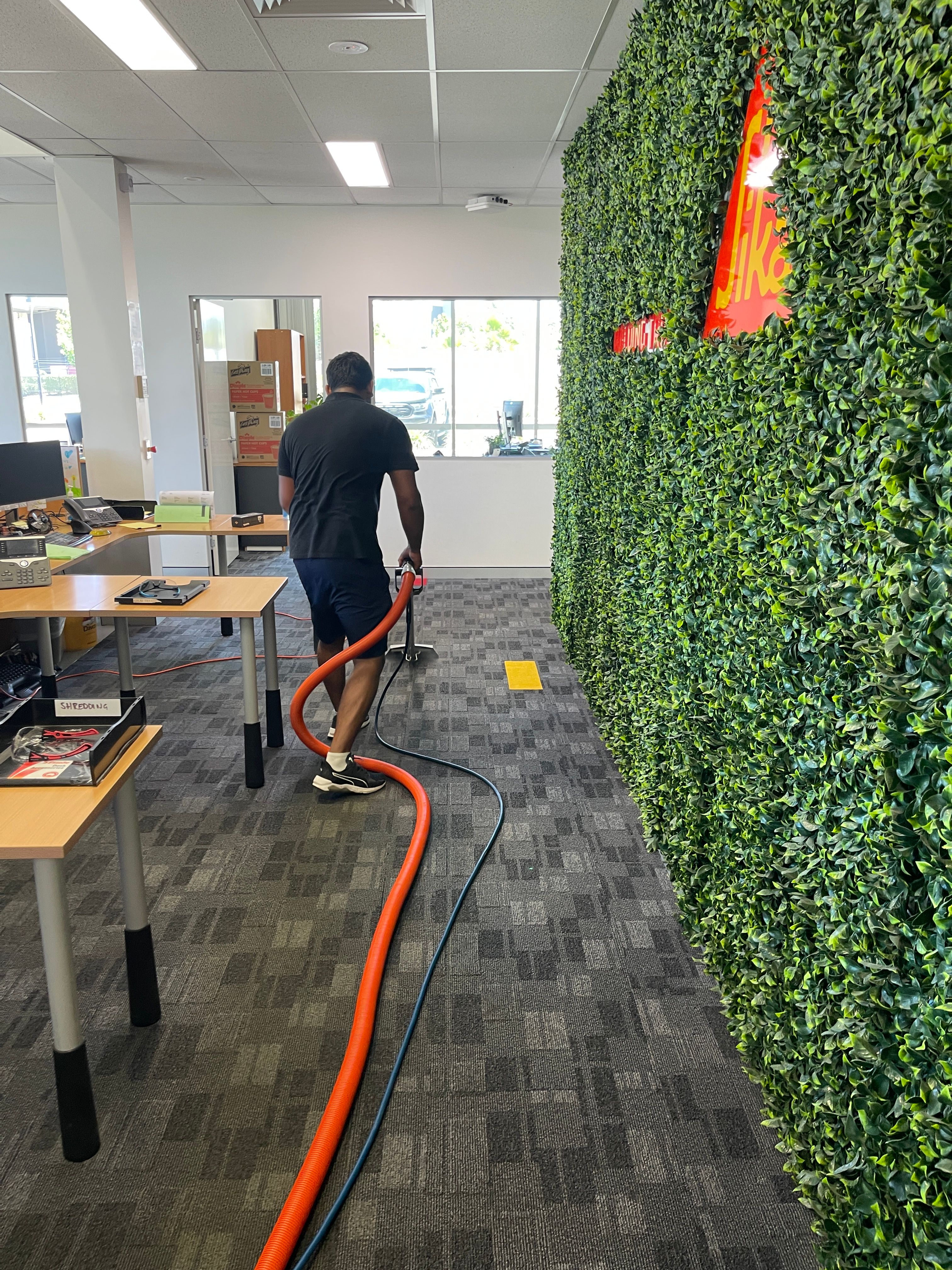 Zavvers carrying out carpet extraction cleaning in an office