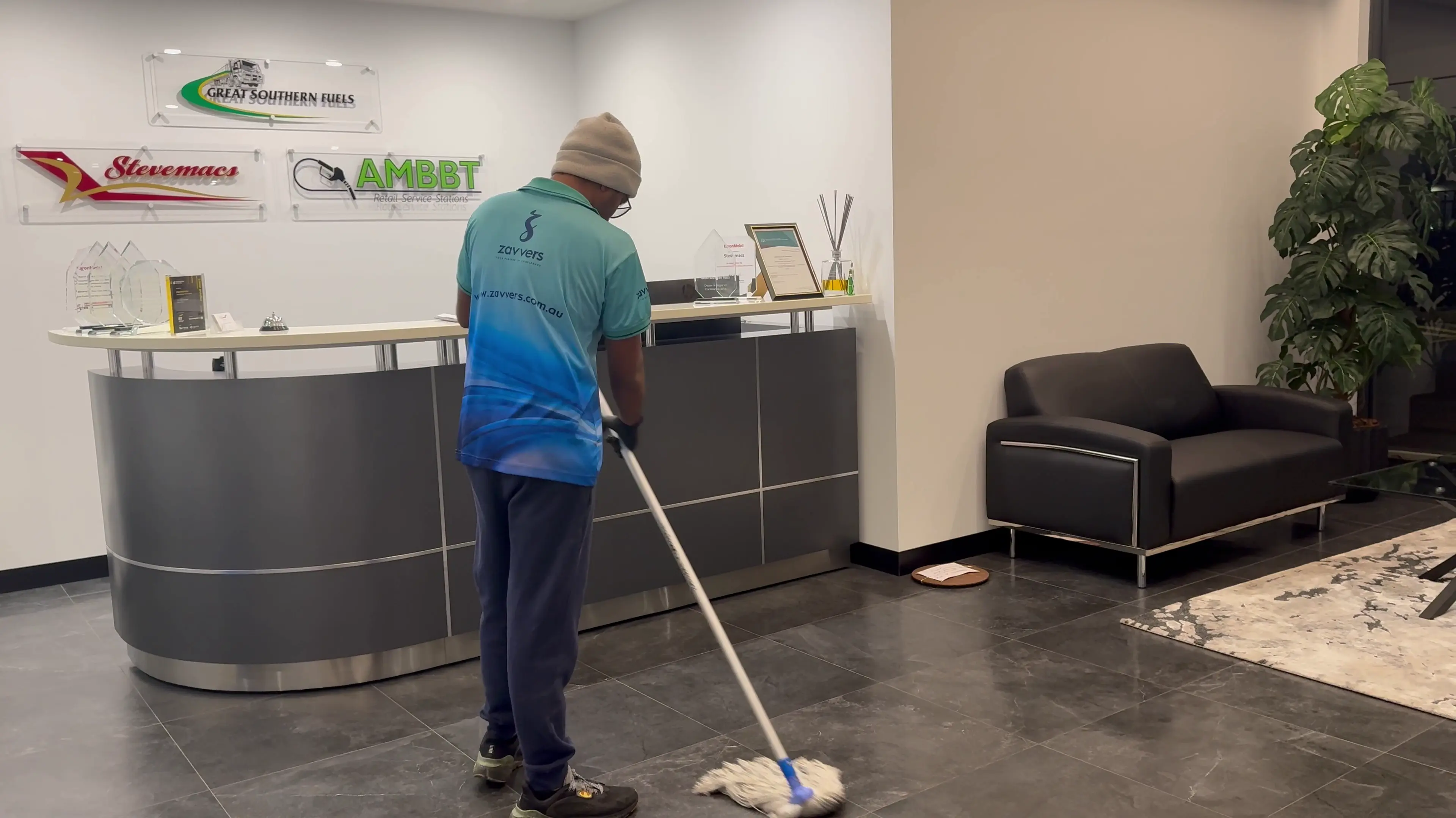 A Zavvers cleaner mopping the floor in an office reception