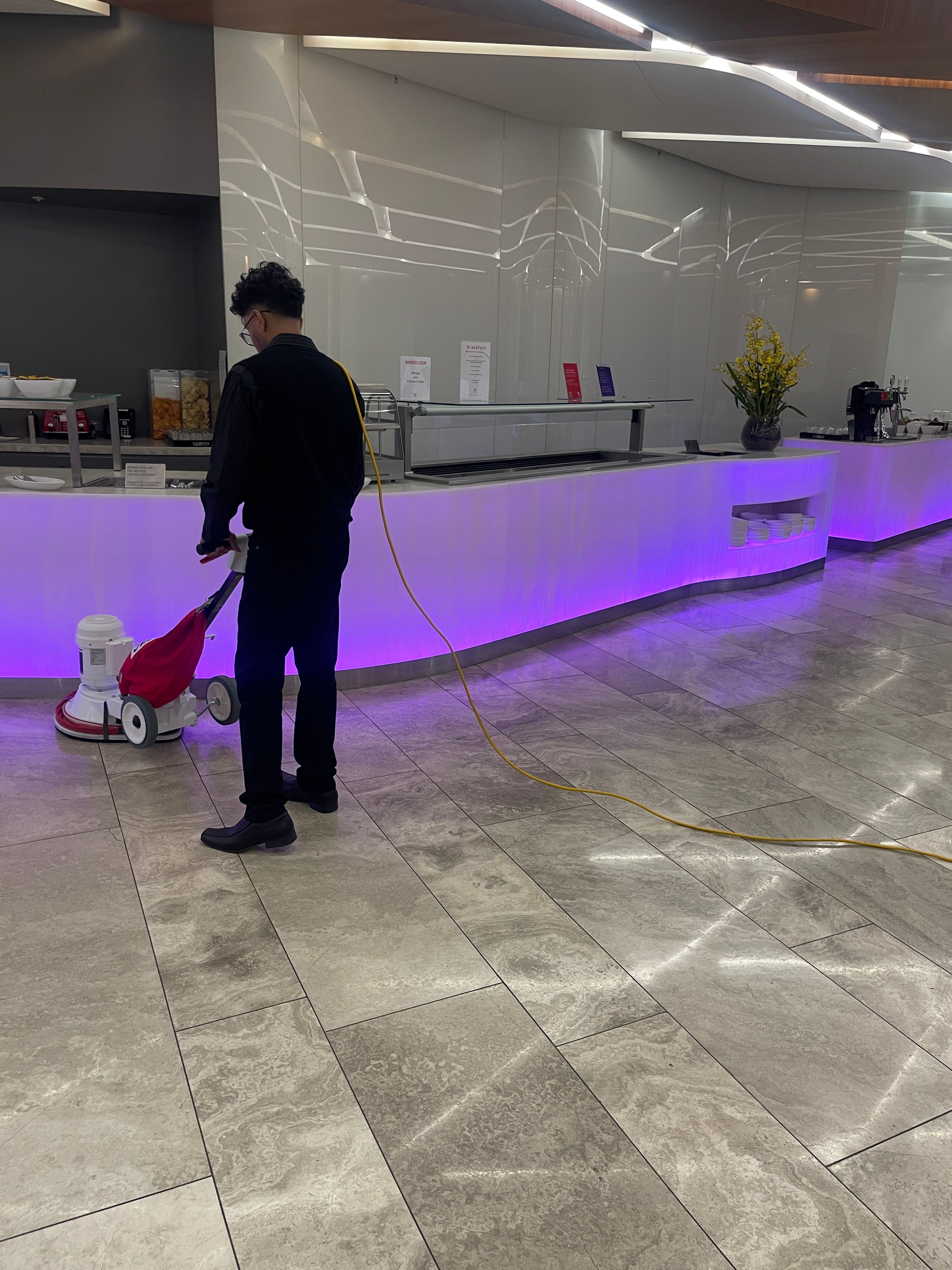 A Zavvers team member using a floor machine in a shared interior